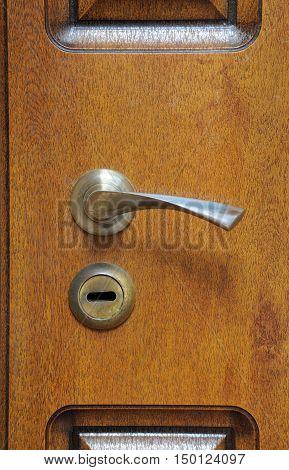 The iron doorhandle on the wooden doors