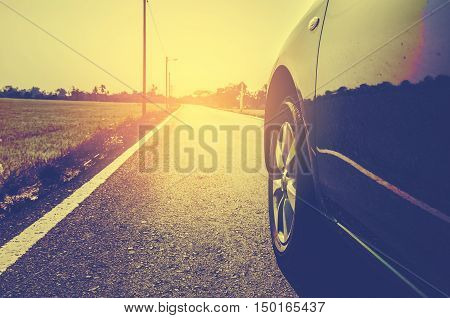 travel concept side view of modern car on road in countryside vintage tone color