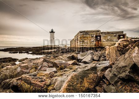 Portsmouth Harbor Lighthouse and Fort Constitution on a cloudy day in early Autumn in natural sepia tones