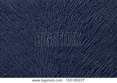 Navy blue background from a soft wool textile material closeup. Fabric with natural texture. Cloth backdrop.