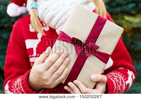 A child holds in hands Christmas present