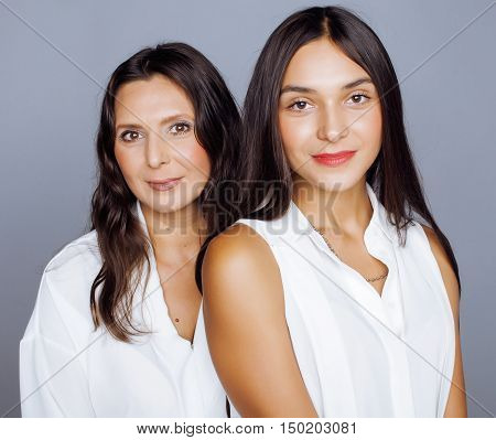 cute pretty teen daughter with mature mothr hugging, fashion style brunette 