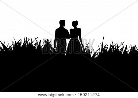 Silhouette of a loving couple in black and white on a background of grass