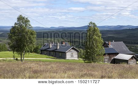 HARJEDALEN, SWEDEN ON JULY 07. View of the countryside and lifestyle up North on July 07, 2016 in Harjedalen, Sweden. Horizon and wooden log buildings on a slope. Editorial use.