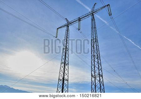 Power pole-high voltage post against blue sky