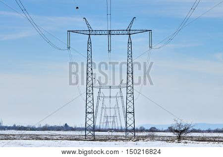 Silhouette of international electrical power line view. Electrical power lines and pylons.