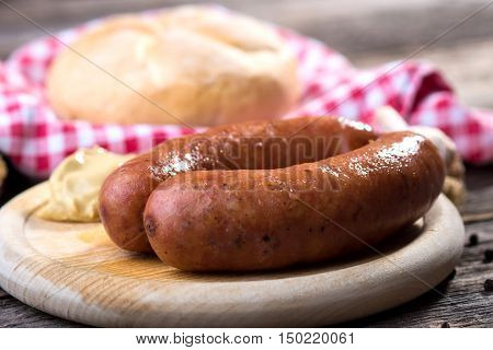 Boiled Sausages On Rustic Round Wooden Board