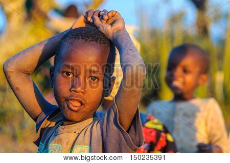 LAKE EYASI, TANZANIA - MAY 29, 2015: Kids from a Datoga tribe playing at sunset at Lake Eyasi Tanzania