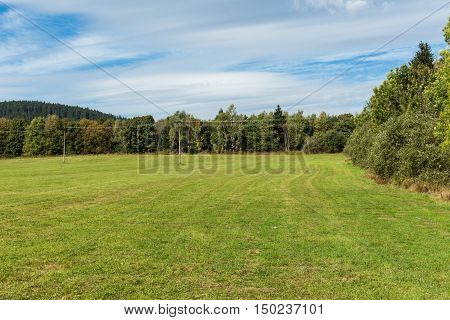 Meadow and forests with blue sky in spring time