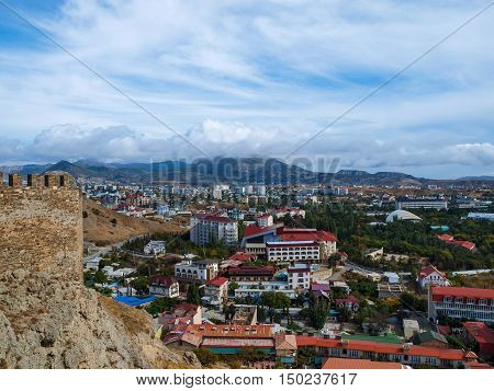View from the ramparts of the ancient to the modern buildings of the town of Sudak in Crimea