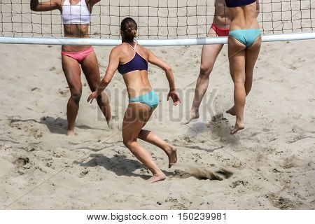Young girls playing Beach Volleyball in sunny day