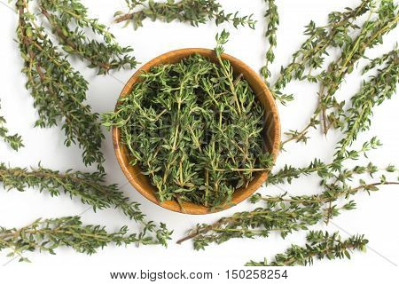 Fresh Thyme into a bowl isolated in white background
