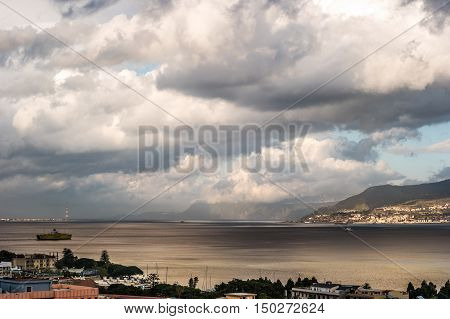 The Messina Strait seen from Sicily Italy. Beautiful moving clouds over vast spaces.