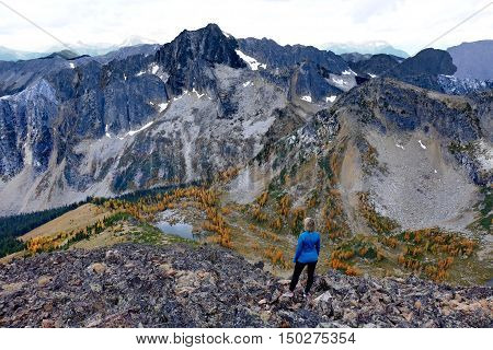 Woman on cliff. Frosty Mountain. Manning Provincial Park. Hope. British Columbia. Canada.