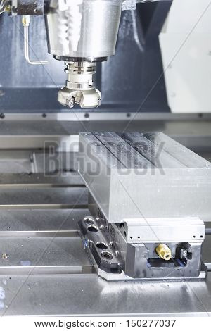 The face milling tool with the raw material work piece on the CNC milling machine.