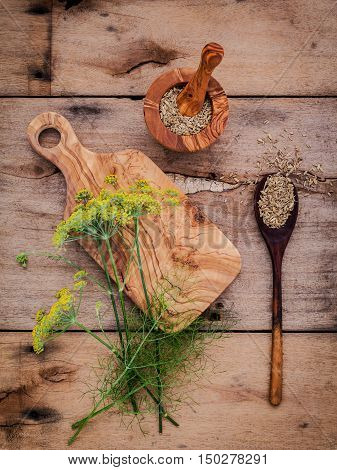 Close Up Blossoming Branch Of Fennel And Dried Fennel Seeds On Rustic Wooden Background With Flat La