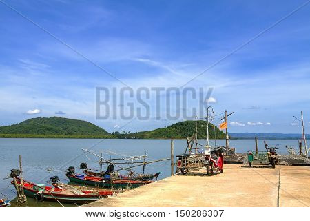 Bright sky and small boat on Kram bay at beach Chumphon Province Thailand