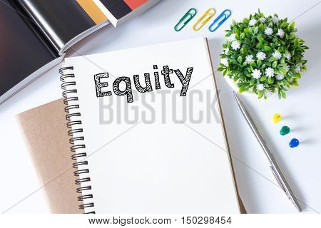equity word message on white paper book and copy space on white desk / business concept / top view