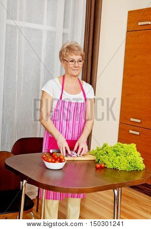 Woman cut red onion on cutting board
