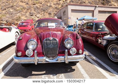 Laguna Beach, CA, USA - October 2, 2016: Red 1958 Jaguar XK 150 FHC owned by Frank Gauer and displayed at the Rotary Club of Laguna Beach 2016 Classic Car Show. Editorial use.