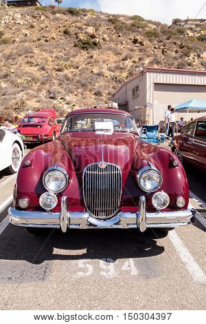 Laguna Beach, CA, USA - October 2, 2016: Red 1958 Jaguar XK 150 FHC owned by Frank Gauer and displayed at the Rotary Club of Laguna Beach 2016 Classic Car Show. Editorial use.