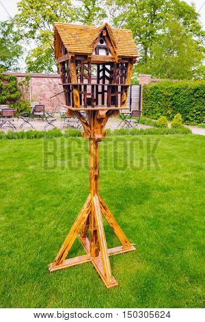 Beautiful bird feeder house stand in english garden