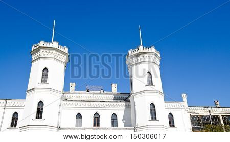 The White Swan palace on blue sky in Sharovka Ukraine
