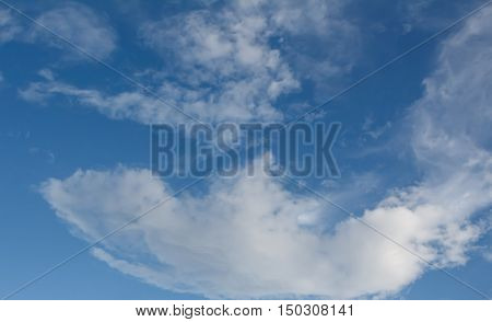 Sky background with the fluffy white clouds