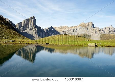 Peaks reflected in Ansabere Lake. Lescun Cirque. Aspe Valley, Pyrenees, France.