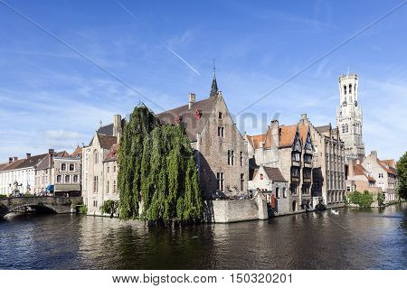 Maarssen, Netherlands, 30 september 2016: old houses along canal in centre of medieval Brugge in Belgium with blue sky in summer