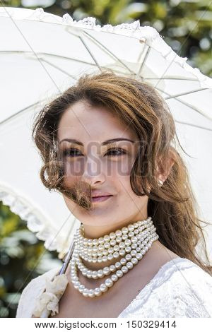 CAGLIARI, ITALY - May 29, 2016: Sunday at La Grande Jatte VIII Ed. At the Public Gardens - Sardinia - portrait of a beautiful girl in Victorian costumes