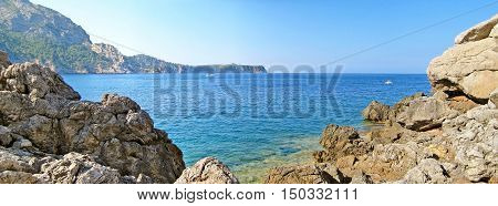 Bay Panorama With Blue Ocean, Rocks And Mountains