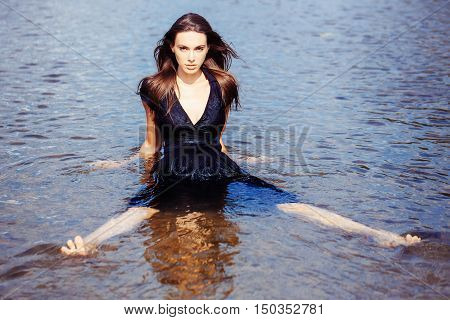 Sexy Young Girl Sits In The Water
