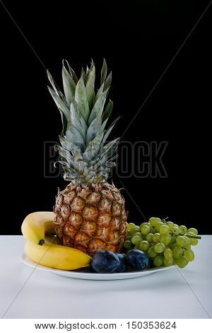Fruit Bowl On A White Table And On A Black Background In The Photo Studio. Vitamin Deser. Bananas, P