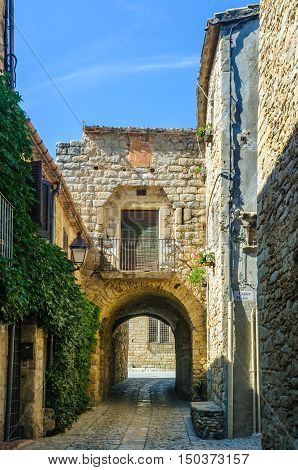 PERATALLADA, SPAIN - SEPTEMBER 26, 2015: The medieval cobbled streets of Peratallada in Catalonia Spain