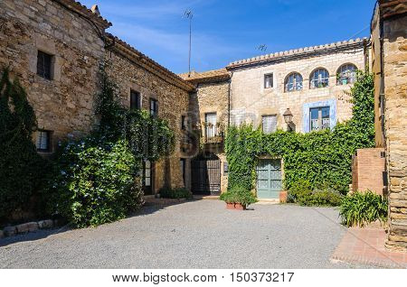 PERATALLADA, SPAIN - SEPTEMBER 26, 2015: Charming small square in Peratallada village in Catalonia Spain