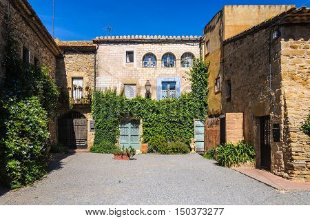 PERATALLADA, SPAIN - SEPTEMBER 26, 2015: Charming small square in Peratallada village in Catalonia Spain