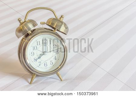 Clock on the bed. The concept is really late.