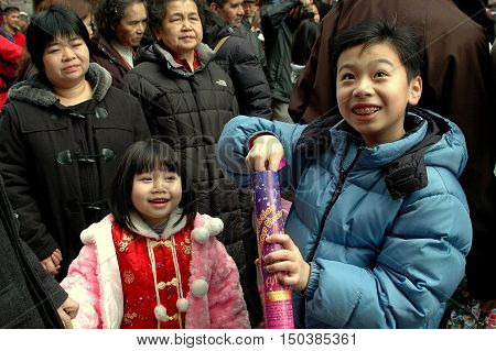 New York City - February 9 2005: Two Chinese children on Mott Street in Chinatown celebrating the Chinese Lunar New Year holiday