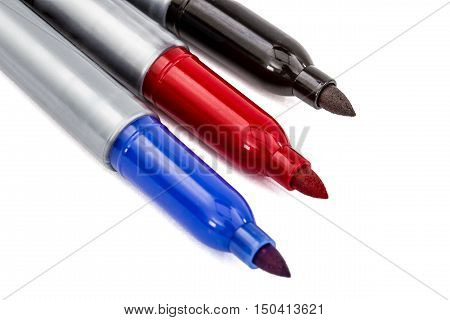 Three felt-tip pens markers highlighters close-up isolated on white background