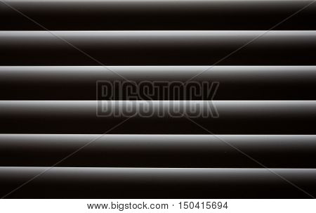 Closed blinds through which light hardly passes. Abstract background blinds