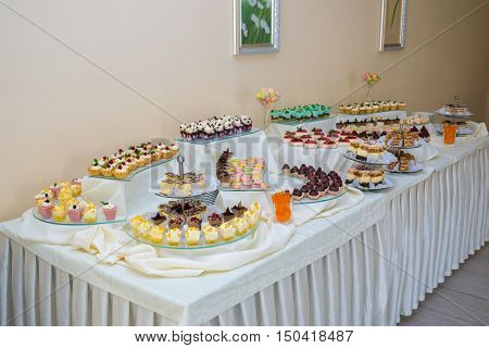 Dessert table for a party. Ombre cake cupcakes. Wedding