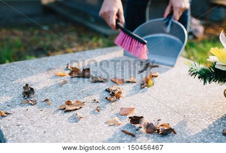 A Woman Cleans The Grave