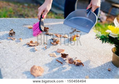 A Woman Cleans The Grave