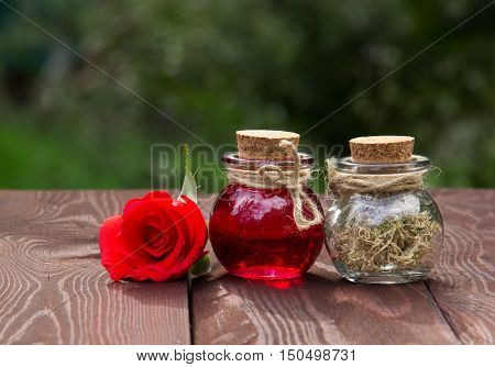 Rose Elixir and herbs for beauty and skin care. Natural cosmetics. Spa concept. Rose oil and aromatherapy. Love drink. Elixir of Love