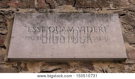 Esse quam videri. A Latin phrase meaning To be, rather than to seem. Engraved text.