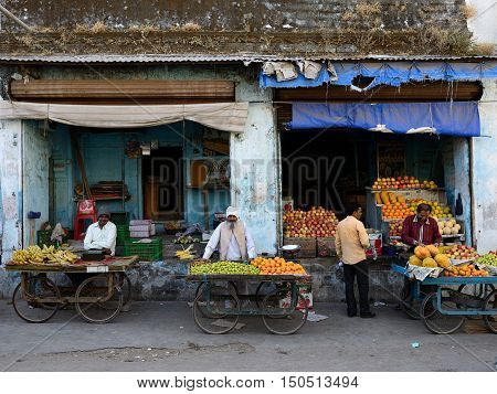 JUNAGADH GUJARAT INDIA - JANUARY 17: Hindus selling vegetables from carts in the street in the Junagadh city in the Gujarat state in India Junagadh in January 17 2015
