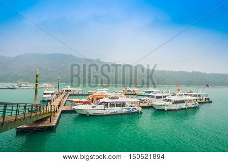 SUN MOON LAKE - MARCH 20: Tourist with boats parking at the pier on March 20 2015 at Sun Moon Lake Taiwan. Sun Moon Lake is the largest body of water in Taiwan as well as a tourist attraction.