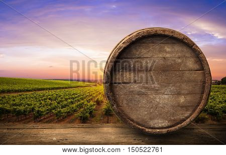 Red wine with barrel on vineyard in green Tuscany, Italy,