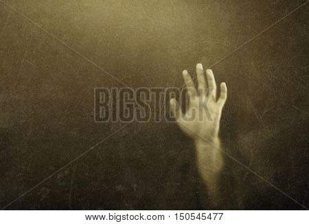 Shadowy figure behind dusty scratched glass 
